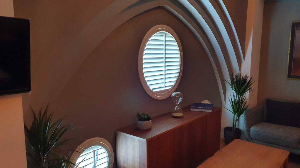 round window with shutters